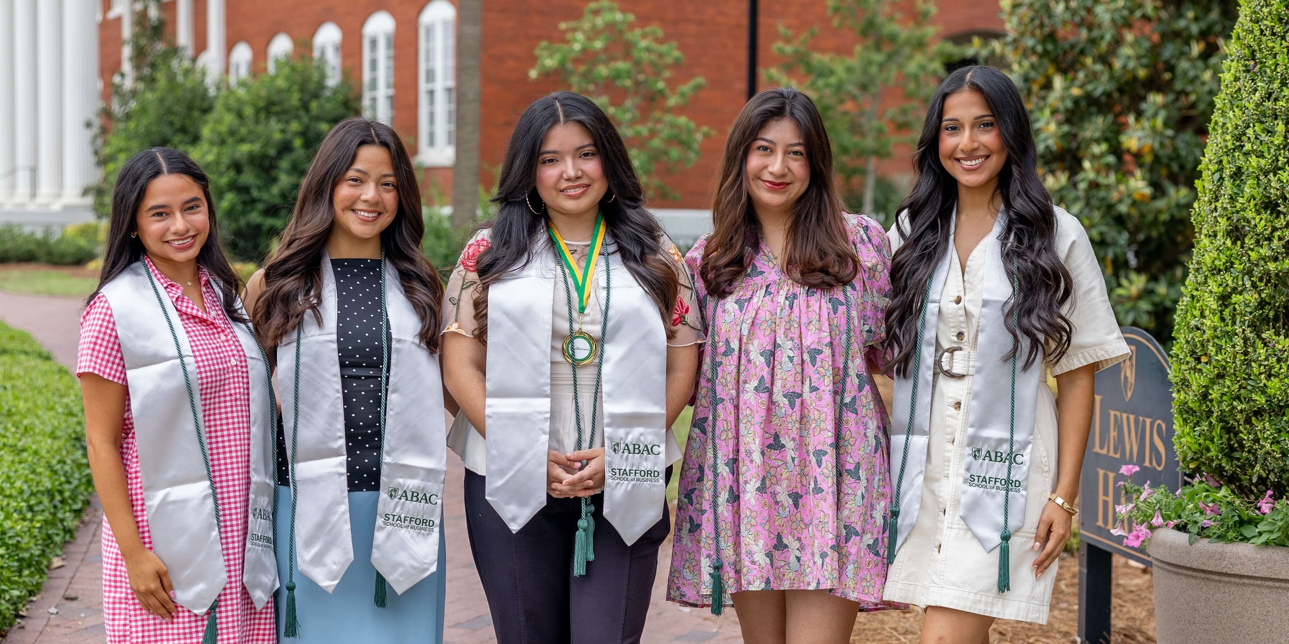 business students wearing graduation gear