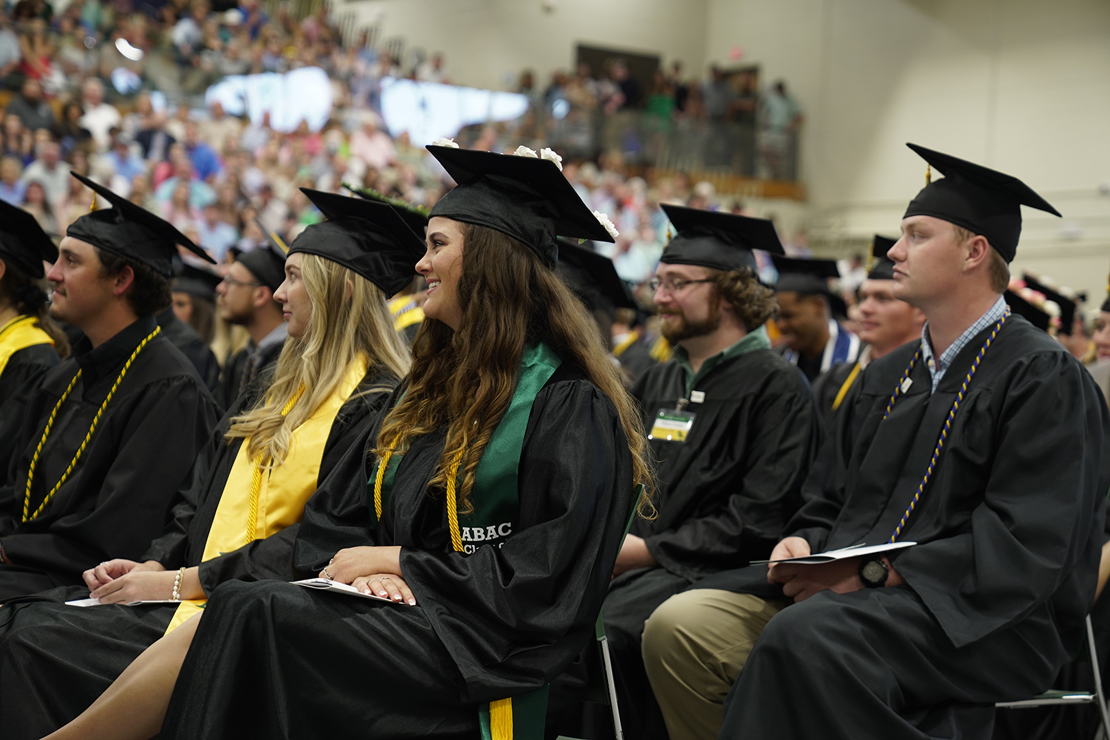 students in caps and gowns at graduation