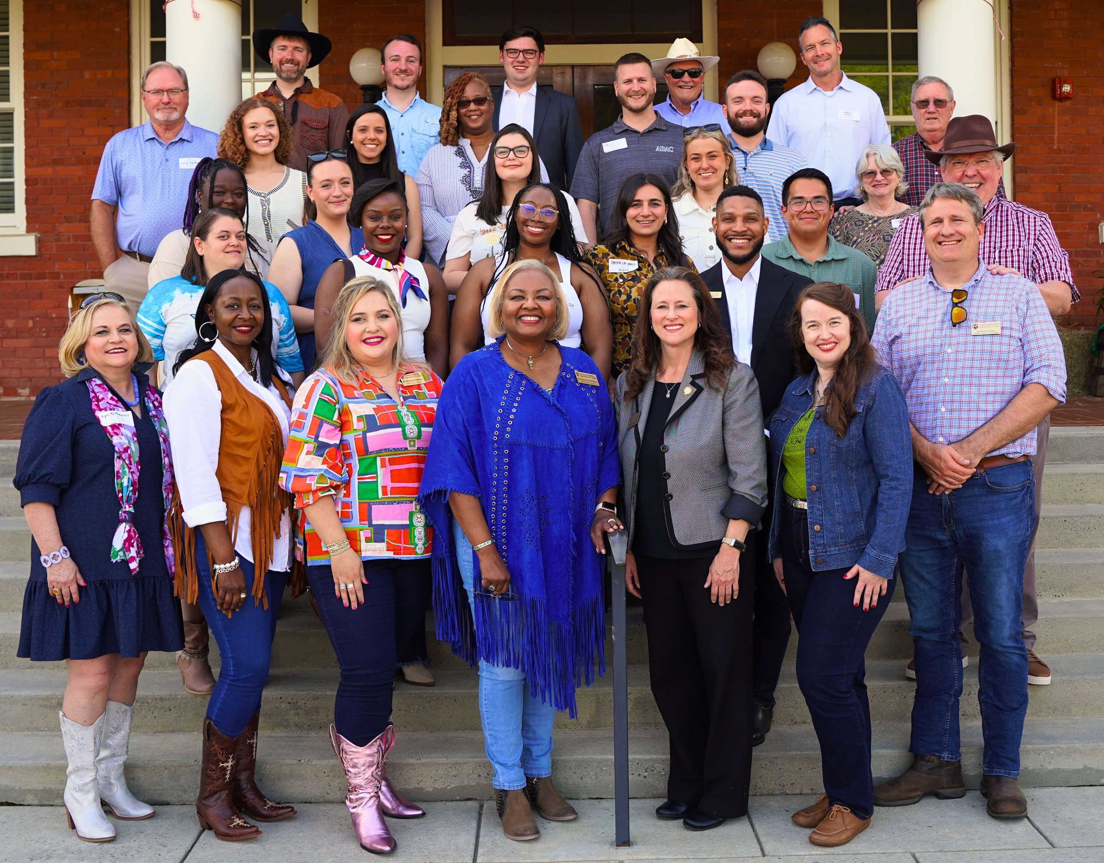 Staff in front of building.