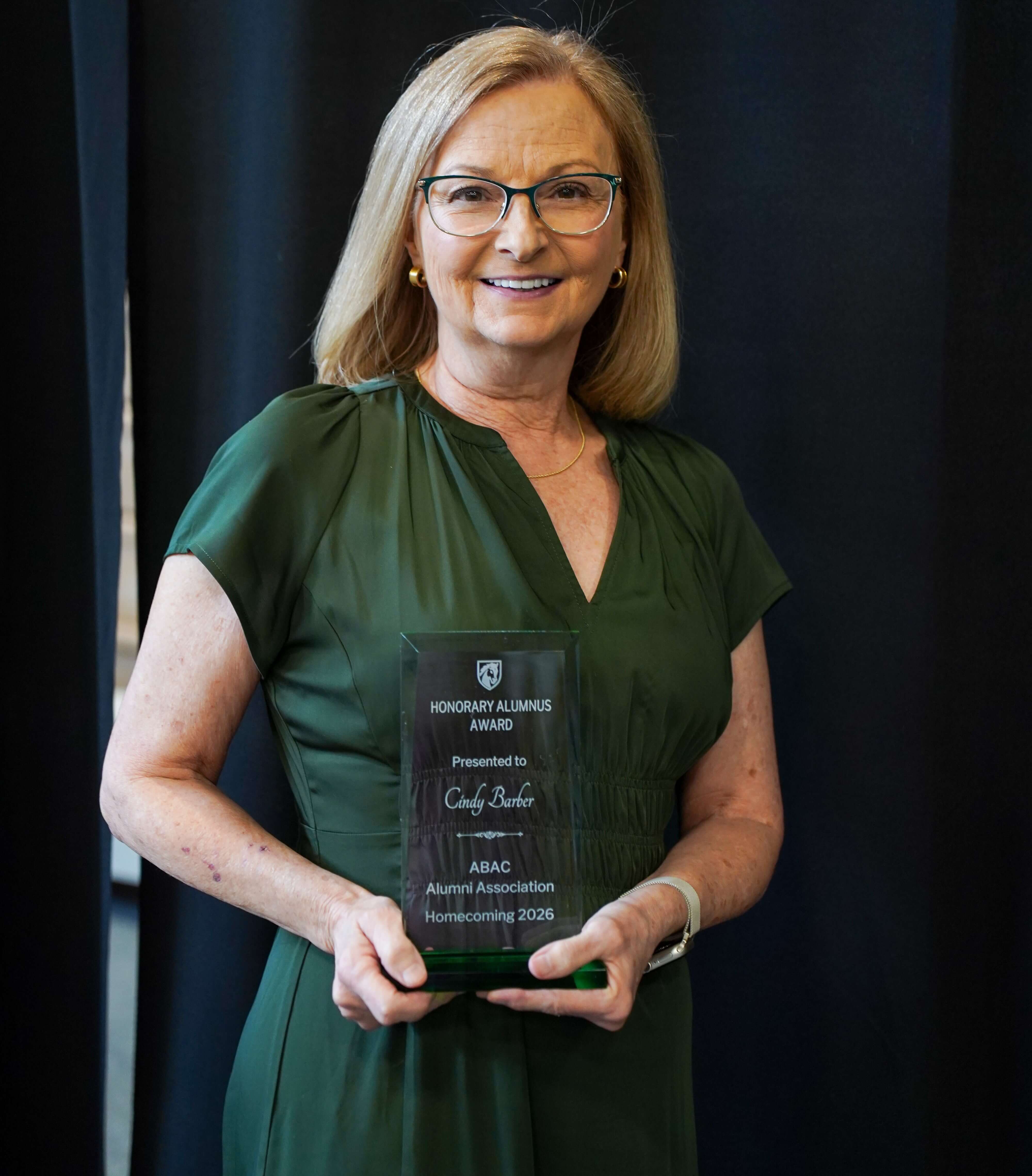 woman holding an award