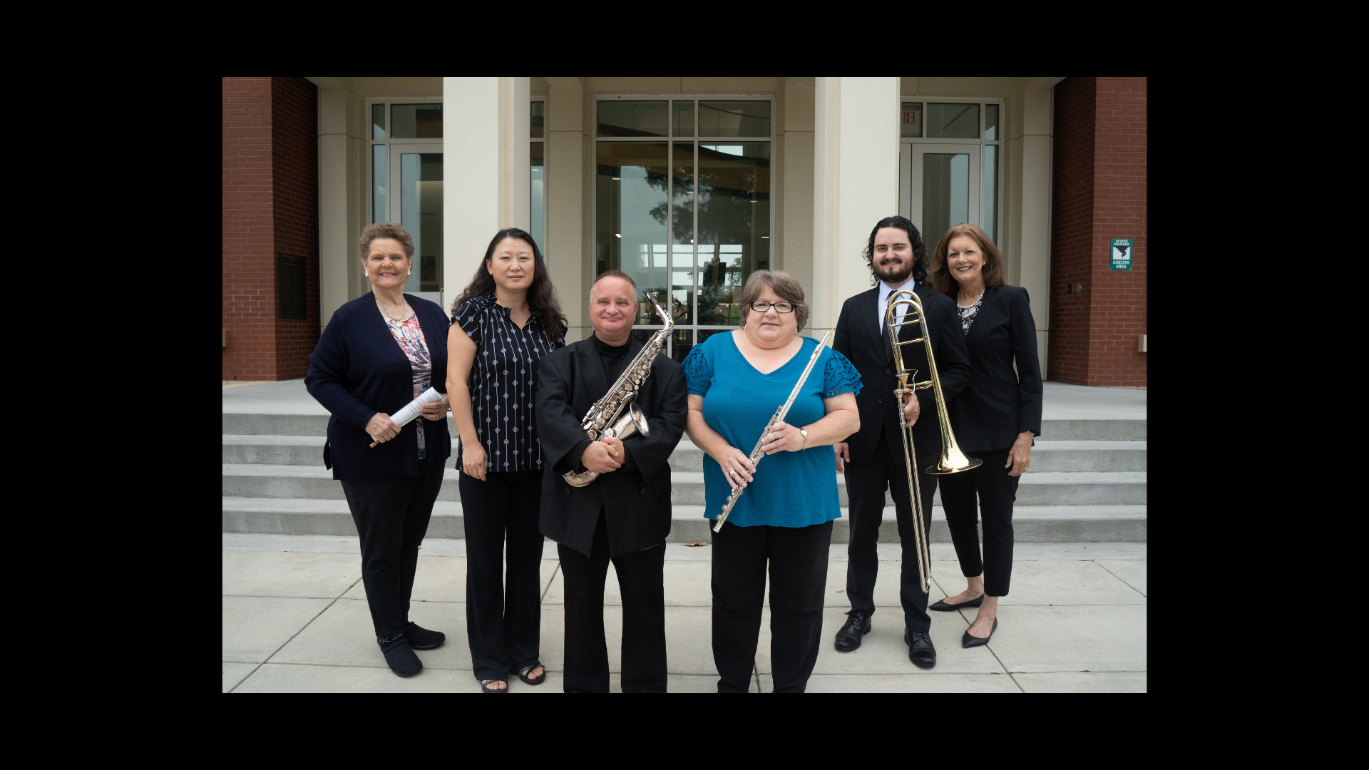 Photo of the ABAC music faculty holding their instruments. 