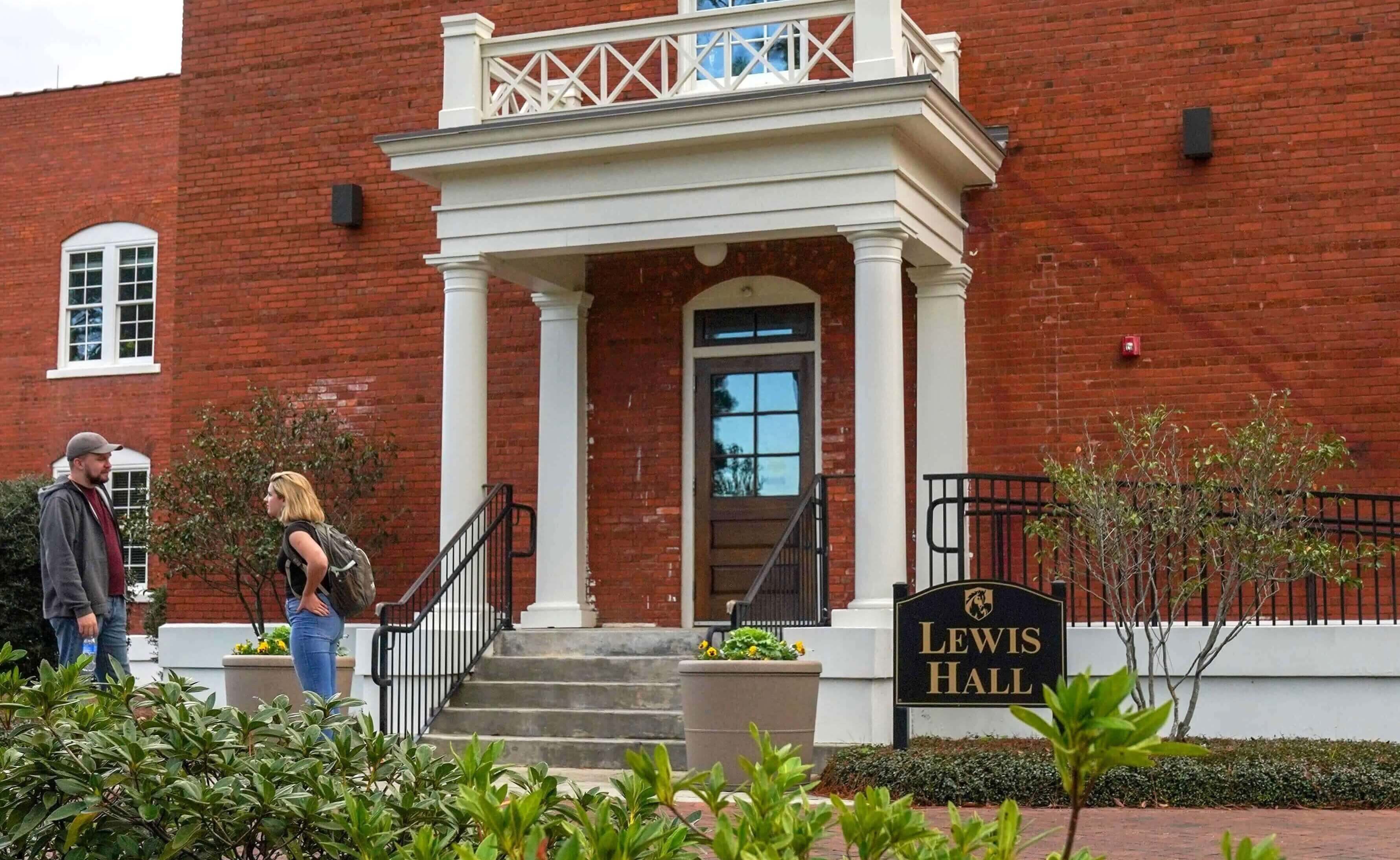 two people meeting outside of a building