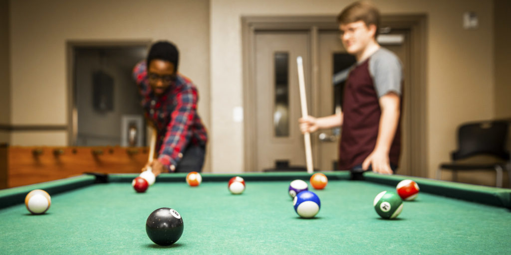 Students playing pool at Lakeside Apartments